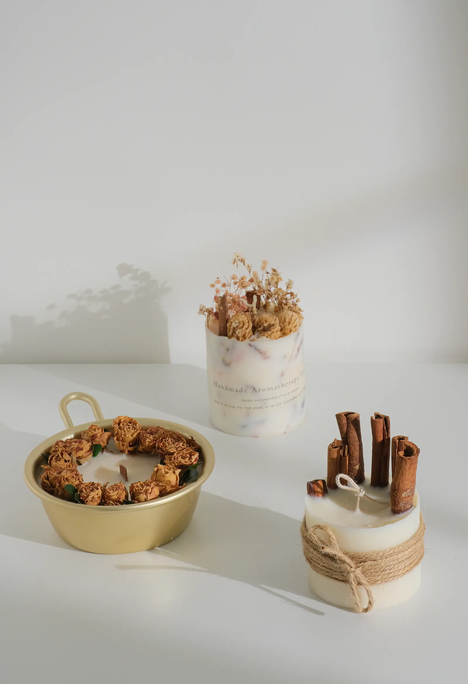Handmade aromatherapy candles with dried flowers and cinnamon